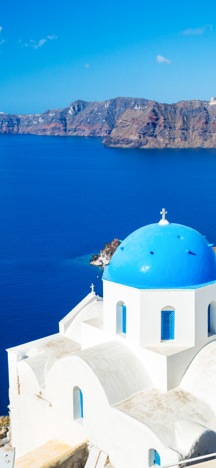 Blue roof and white wall buildings in Santorini phone wallpaper