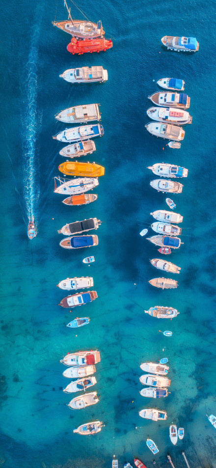 Boats Floating on Turquoise Sea 4K Phone Wallpaper