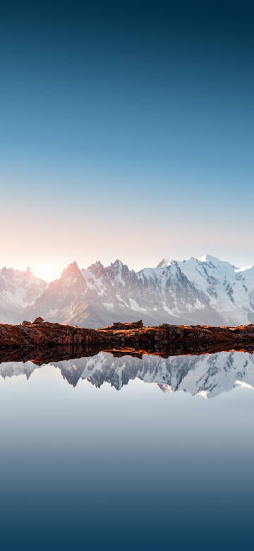 Snow-covered mountains in the morning light phone wallpaper