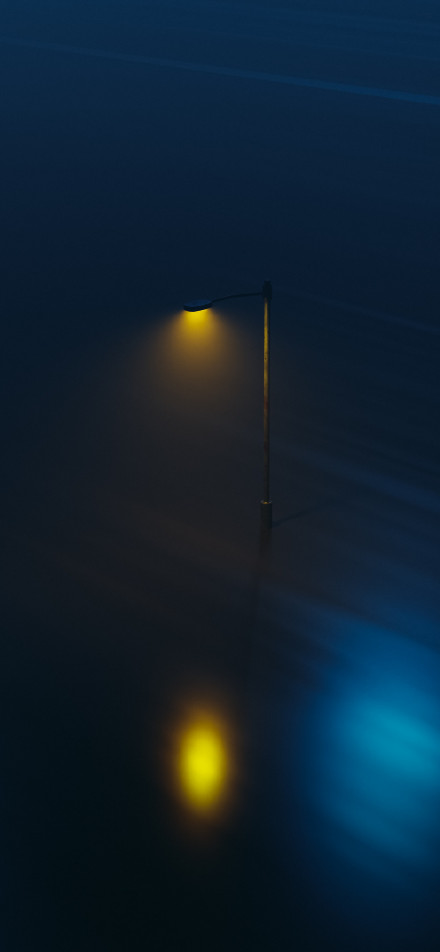 Street lamp emitting soft yellow light in the dark