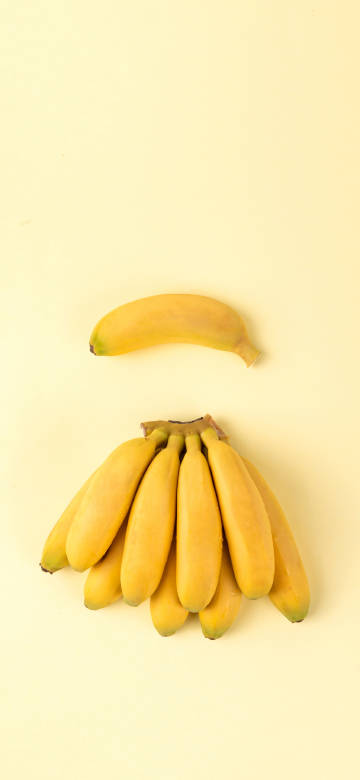 Bananas on yellow background 4K Phone Wallpaper