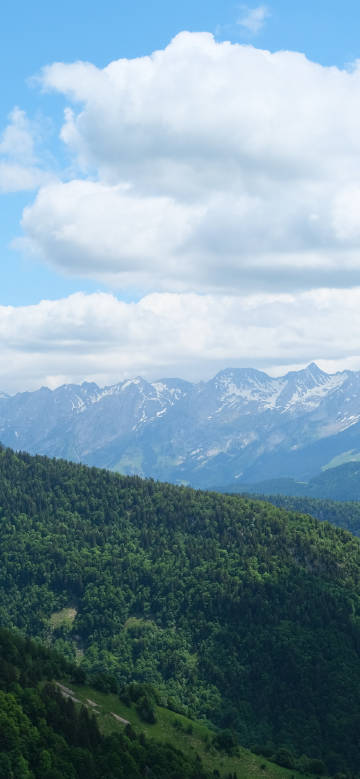 Magnificent mountains under blue sky and white clouds phone wallpaper