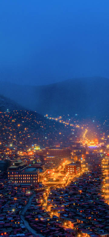 A city lit up at night phone wallpaper