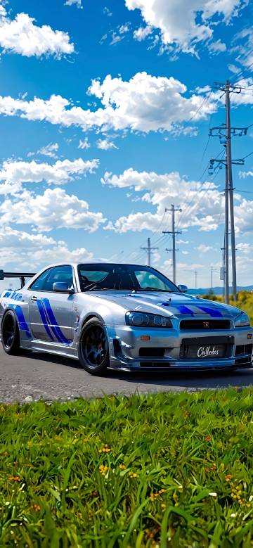 Silver Nissan R34 GTR Driving Under Blue Sky