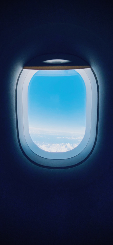 Blue sky and white clouds outside the airplane window phone wallpaper