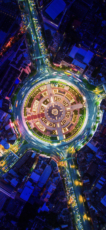 Overlooking the brightly lit city roundabout phone wallpaper