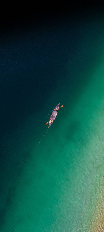 Nubia Z50 Ultra Wallpaper: Canoe on blue-green water