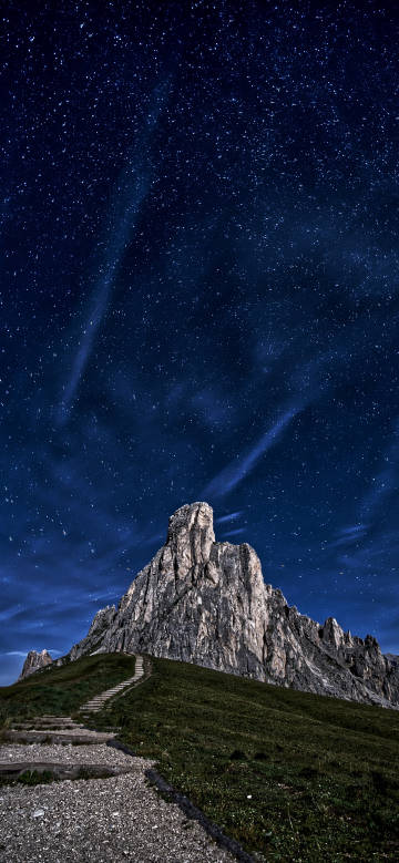 Soaring peaks under a blue starry sky phone wallpaper