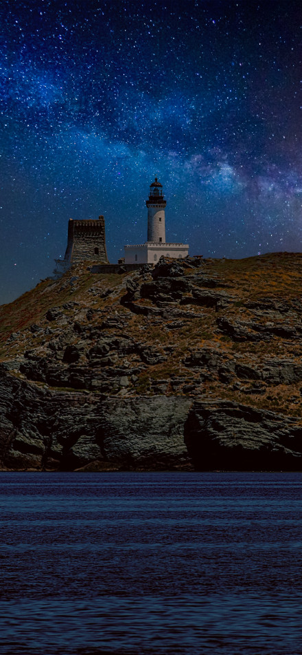 Lighthouse under starry sky phone wallpaper