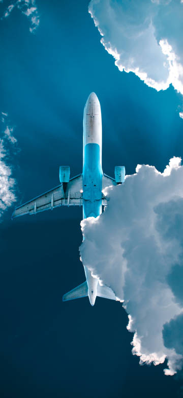 An airplane flying through the white clouds phone wallpaper