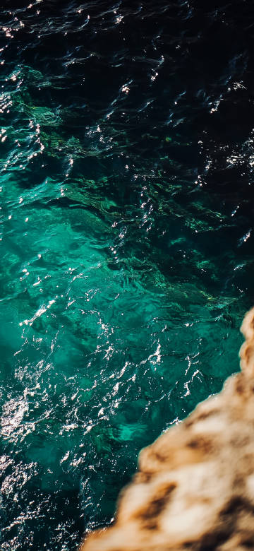 Clear sea water under rocks at the seaside