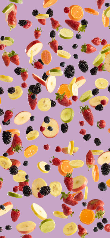 Floating Sliced Fruits on Pink Background Wallpaper