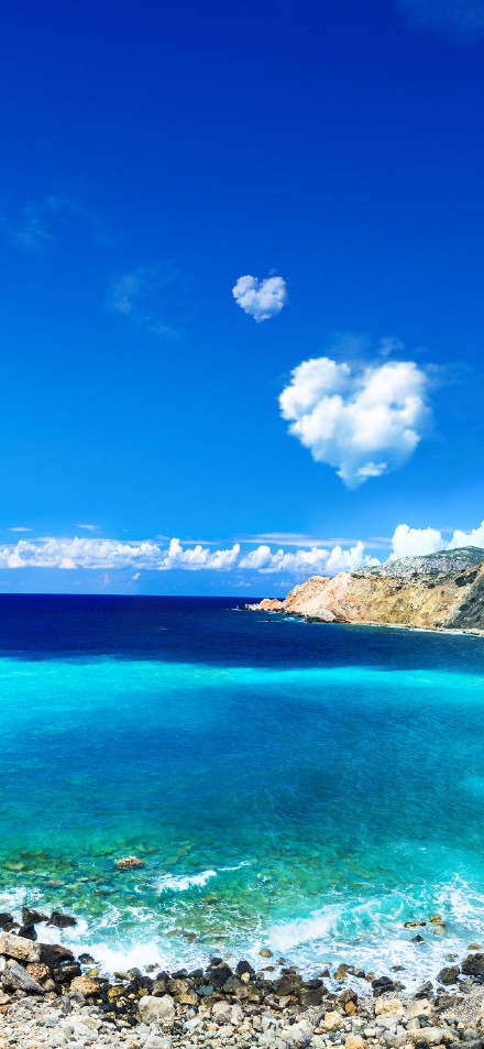 Landscape wallpaper: clear skies, blue sea and rocky shores