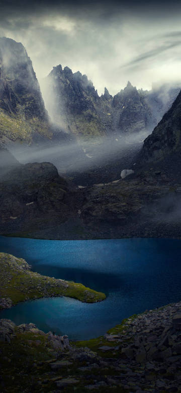 Lake and mountains shrouded in clouds phone wallpaper