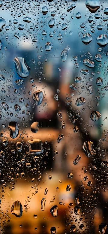 Shimmering Water Beads on Glass Close-up