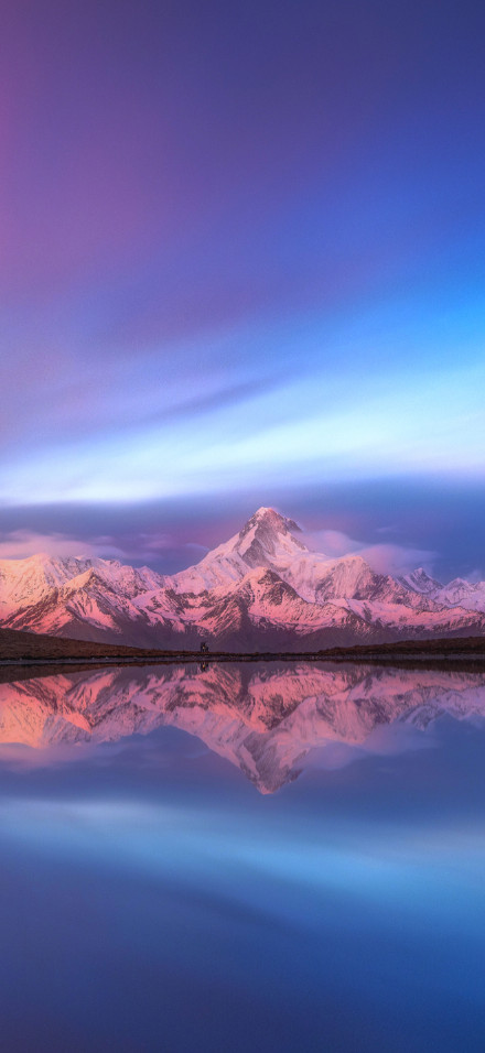 Snow mountain reflection under pink-blue sky