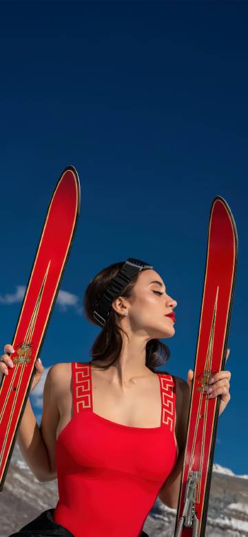 Beautiful women skiing on snowy mountains fashion photo wallpaper