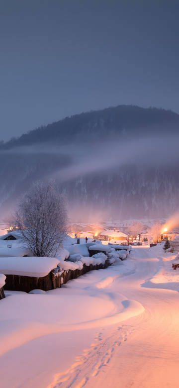 Snowy winter village scene phone wallpaper