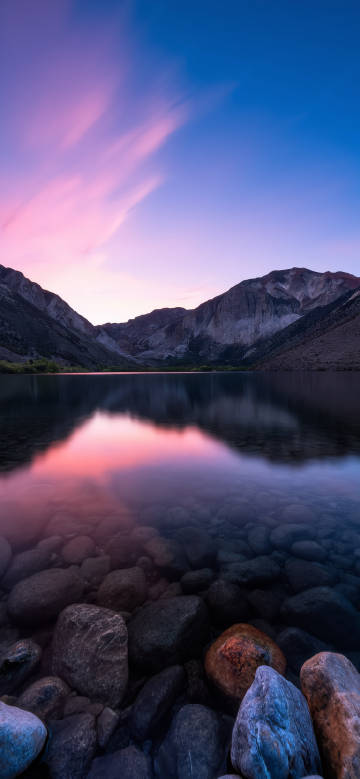 Tranquil landscape under purple sunset phone wallpaper