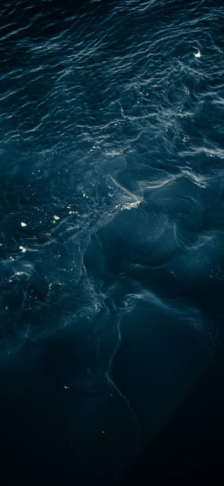 A deep blue sea with undulating water phone wallpaper
