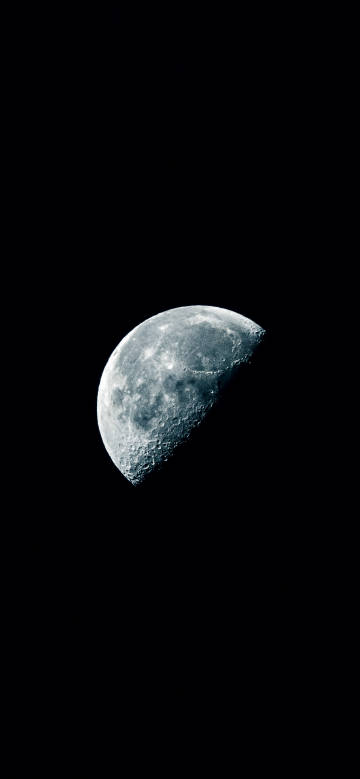 A half-moon in a deep black night sky phone wallpaper