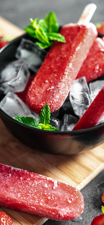 Red popsicles on a bowl of ice phone wallpaper