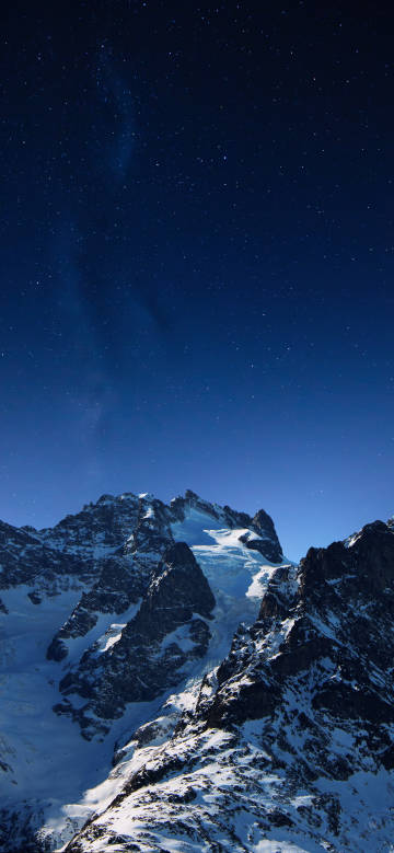 Night view of snowy mountains and starry sky phone wallpaper