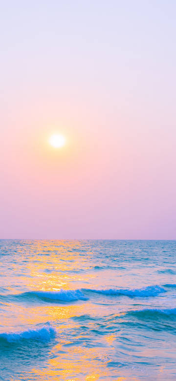 Sunset over the sea in pastel tones phone wallpaper