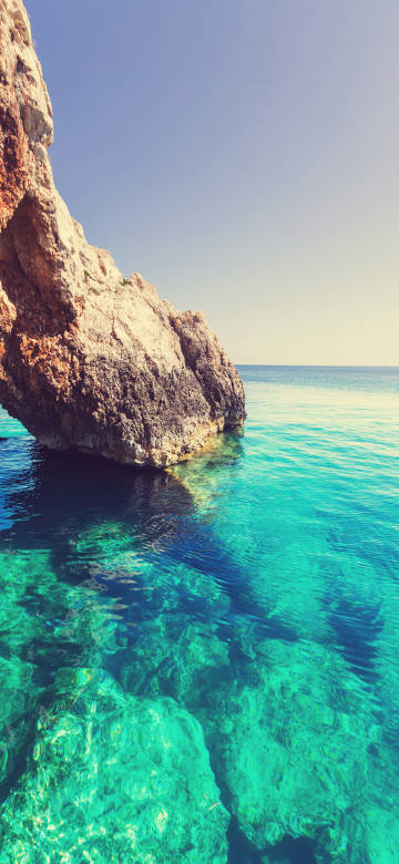 Clear turquoise sea by the beach phone wallpaper
