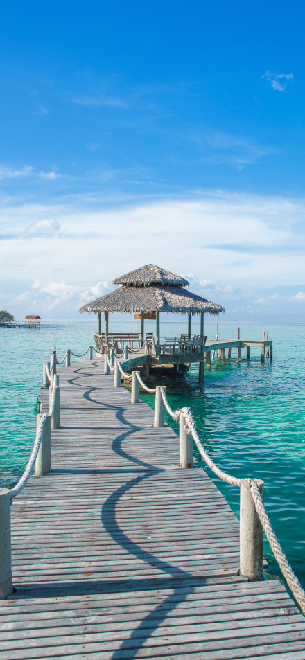 Peaceful Ocean Hut With Clear Sky 4K Phone Wallpaper