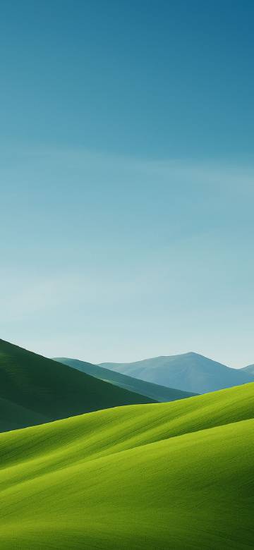 Green hills under clear sky phone wallpaper