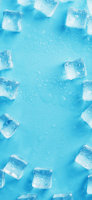 Transparent ice cubes with water drops on blue background