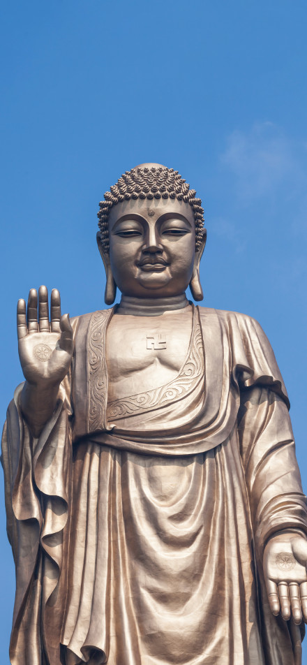 Majestic Buddha Statue with Blue Sky 4K Phone Wallpaper