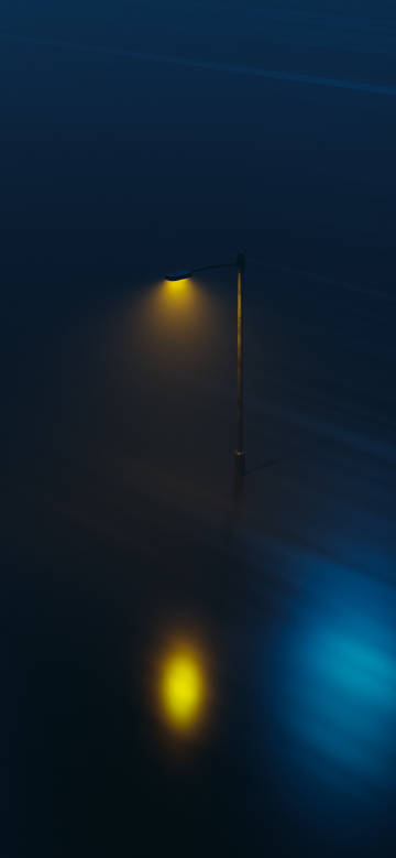 Street lamp emitting soft yellow light in the dark