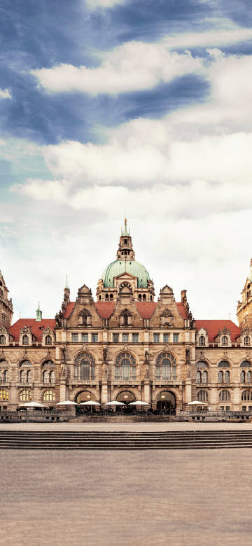 Hannover Town Hall under blue sky and white clouds phone wallpaper