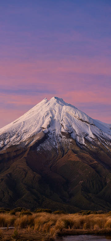 Sunset over snow-capped mountain phone wallpaper