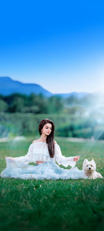 Woman with white dog on grass phone wallpaper