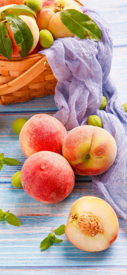 Fresh Juicy Peaches on a Blue Wooden Table