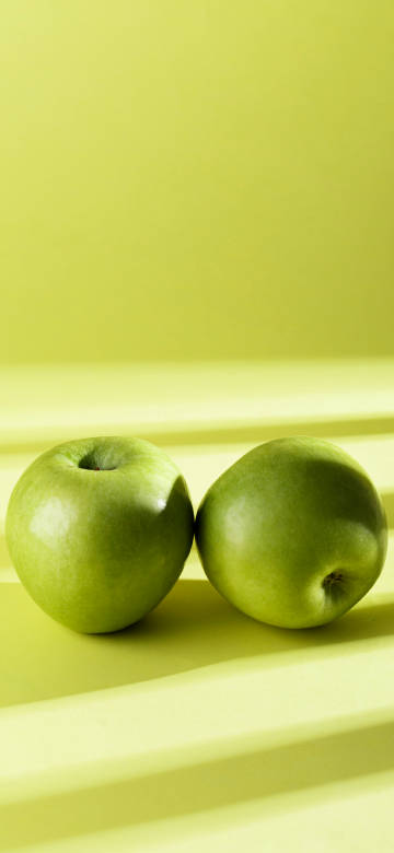 Fresh Green Apples On Yellow Background 4K Phone Wallpaper