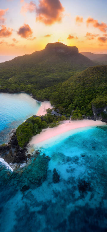 Aerial View of a Dreamy Beach: Sunset and Clear Seas