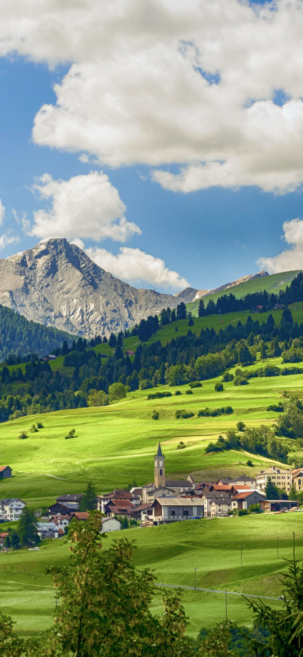Village on green hillside phone wallpaper