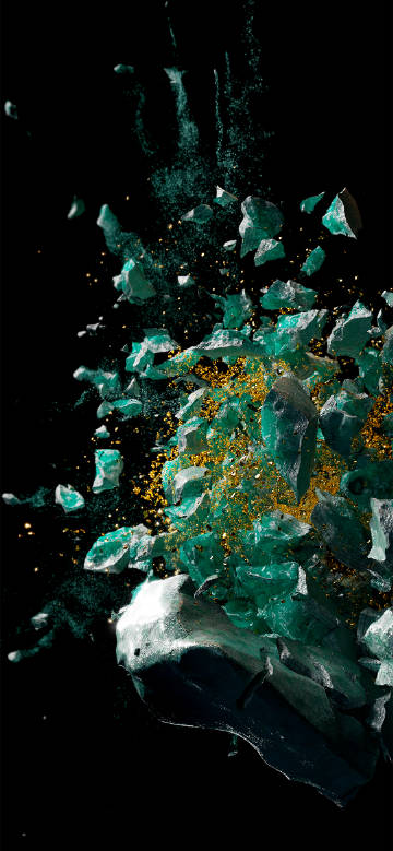 Moment of shattering of emerald green crystal against black background