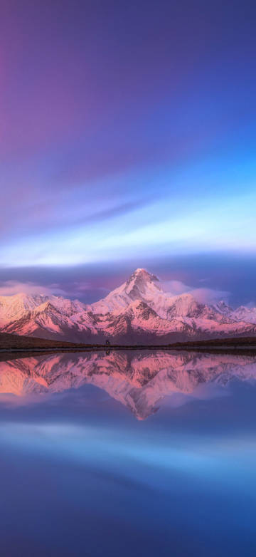 Snow mountain reflection under pink-blue sky