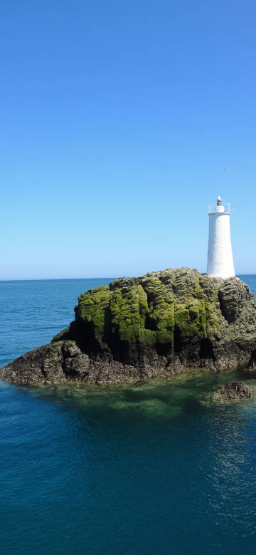 Beautiful white lighthouse with pure blue sky phone wallpaper