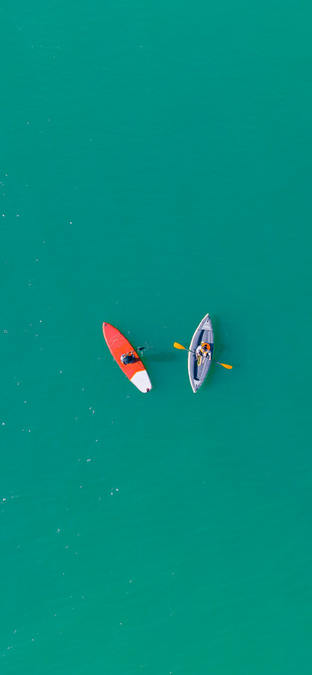 Paddleboard and kayak journey on blue water phone wallpaper