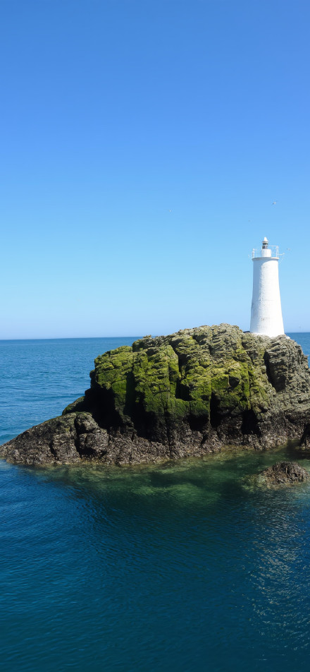 Beautiful white lighthouse with pure blue sky phone wallpaper