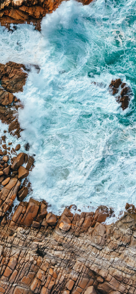 Breathtaking view of waves crashing against the rocks on the sea shore