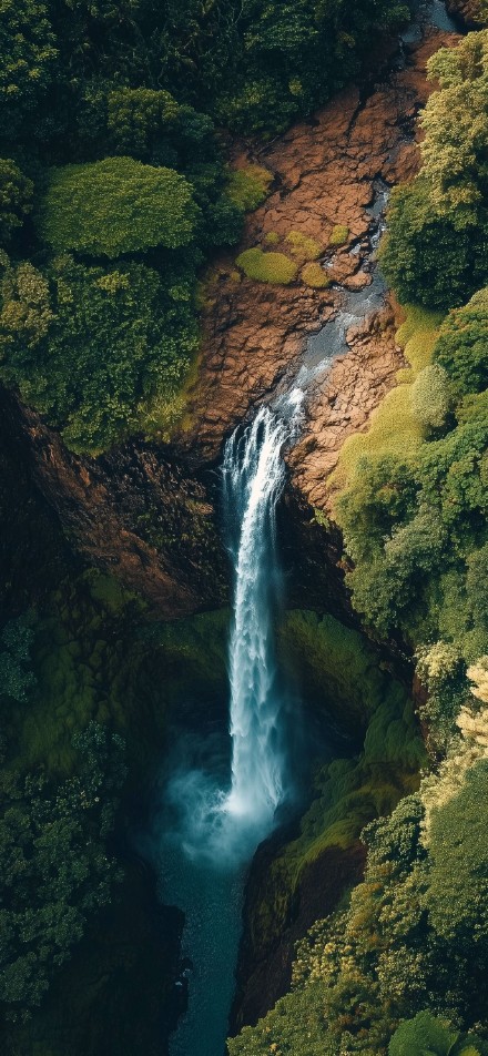 Natural Wonder: Stunning Waterfall in Tropical Jungle Wallpaper