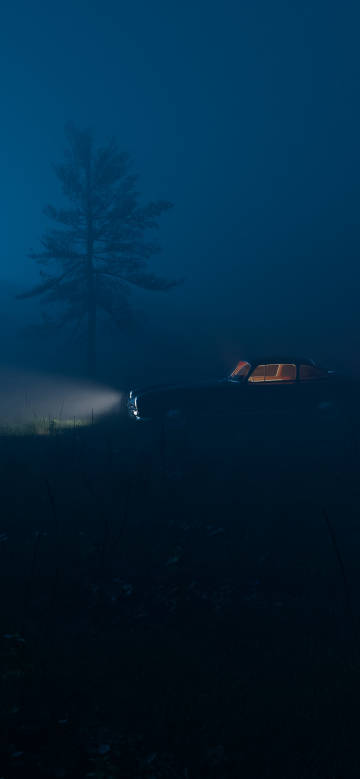 Car with lights on in the night fog phone wallpaper