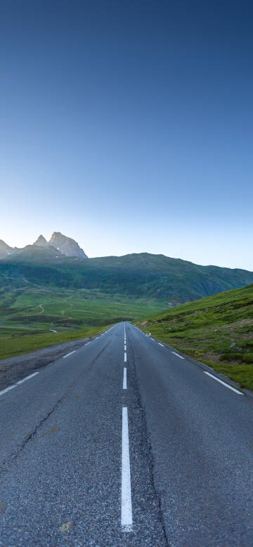 Scenic highway under blue sky phone wallpaper